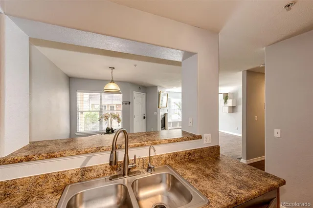 a living room with kitchen island granite countertop furniture and a fireplace