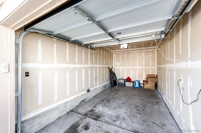 a view of a house with brick walls plants and large tree