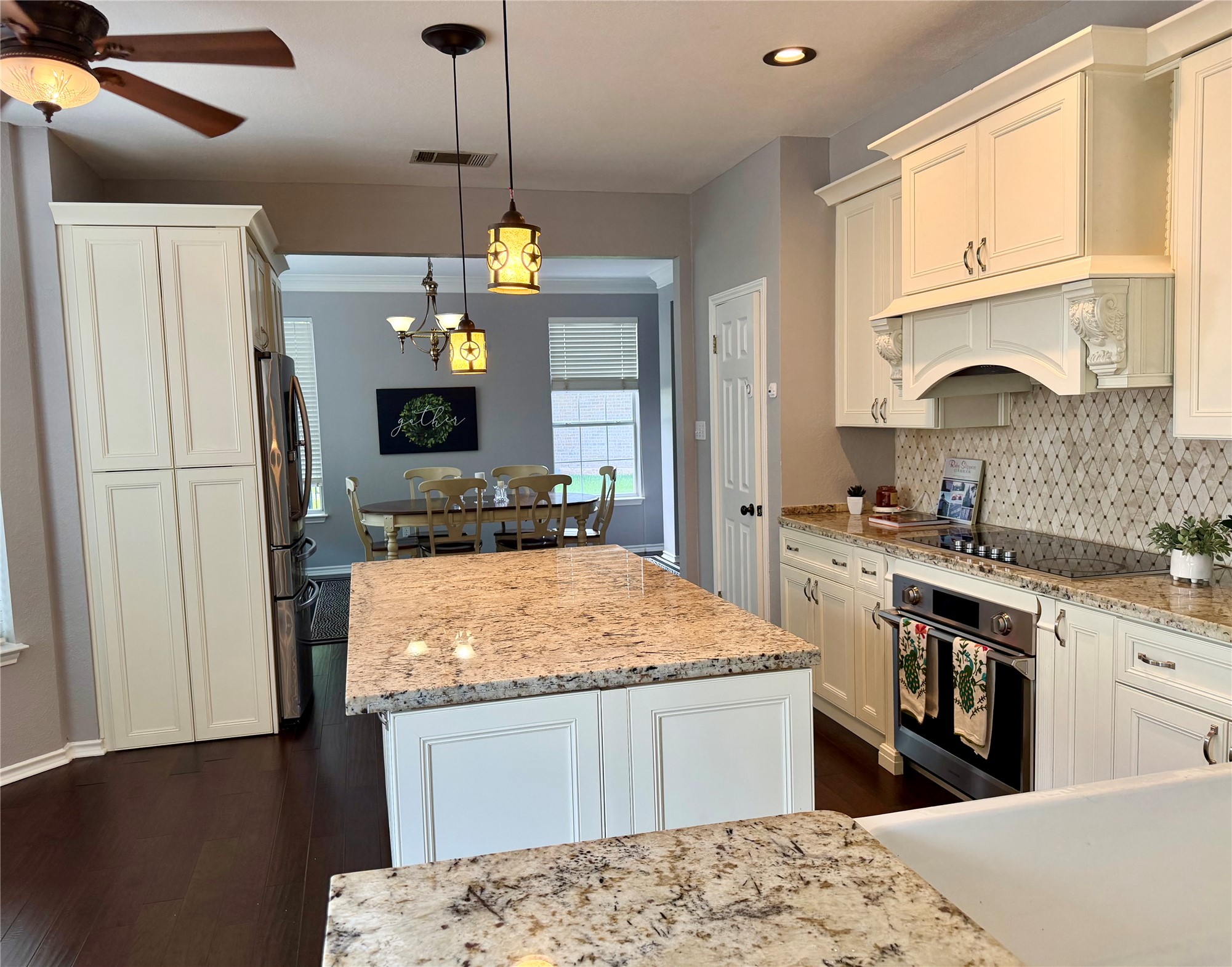 13 Oak View Round Rock, TX 78664 - Photo 10 of 30 Chef's kitchen with granite countertops and rich wood flooring flows into a charming dining area.