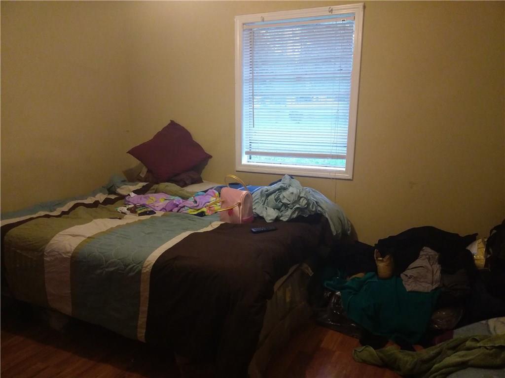 3384 Hopkins Road Powder Springs, GA 30127 - Photo 1 of 1 a bed sitting in a bedroom next to a window