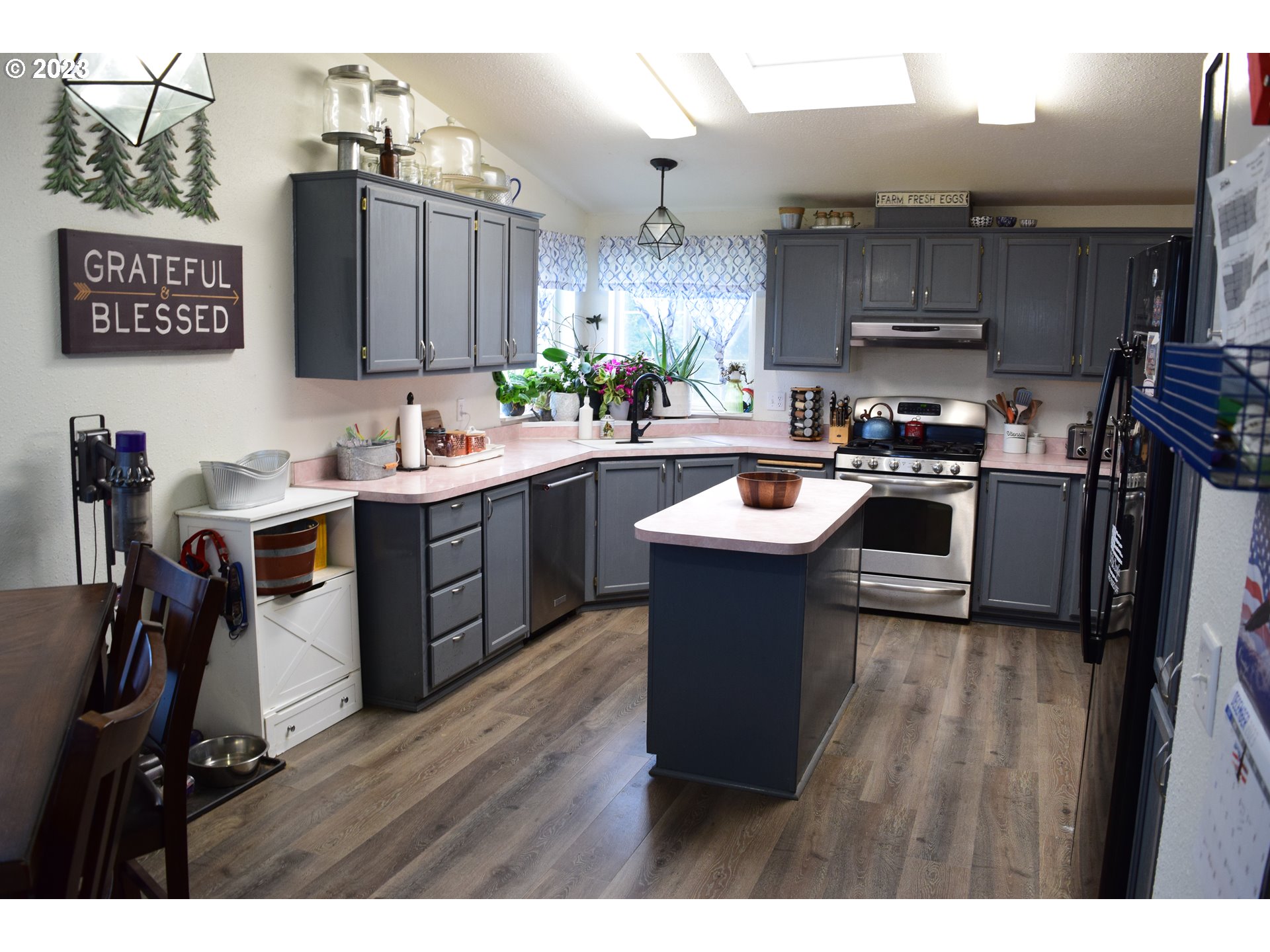 37075 Southeast Trubel Road Sandy, OR 97055 - Photo 6 of 15 a kitchen with stainless steel appliances a sink a stove a refrigerator cabinets and wooden floor