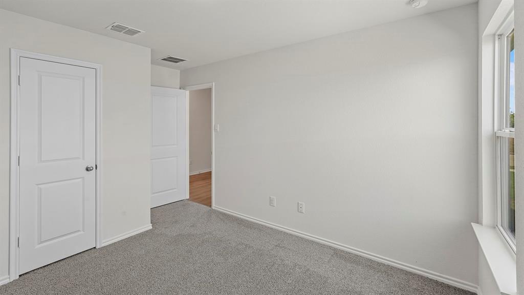 628 Dunham Road Farmersville, TX 75442 - Photo 10 of 36 Light gray carpeting, white painted walls, white two-panel doors, and a white window frame