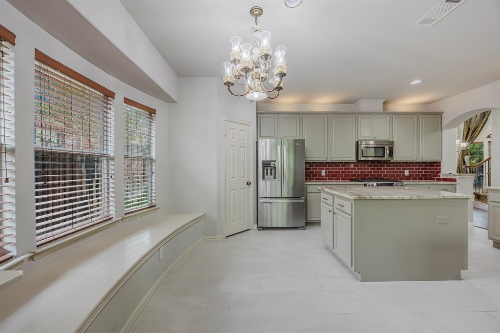 362 Spring Meadow Drive Fairview, TX 75069 - Photo 11 of 38 a kitchen with stainless steel appliances granite countertop a refrigerator and a sink