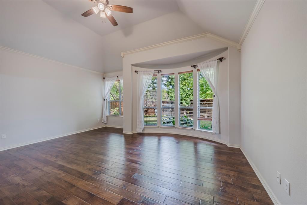 362 Spring Meadow Drive Fairview, TX 75069 - Photo 19 of 38 a view of an empty room with wooden floor fan and a window
