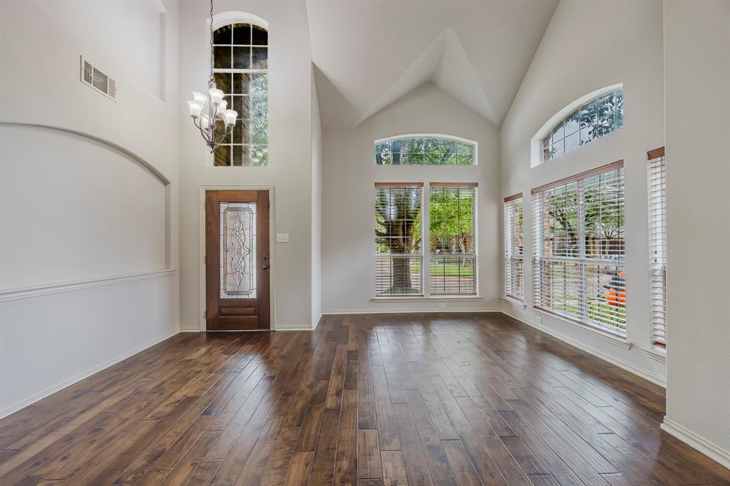 362 Spring Meadow Drive Fairview, TX 75069 - Photo 2 of 38 a view of an empty room with wooden floor and a window