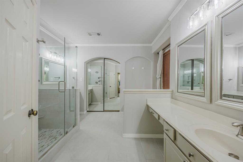 362 Spring Meadow Drive Fairview, TX 75069 - Photo 22 of 38 a spacious bathroom with a shower sink and mirror