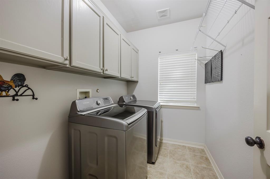362 Spring Meadow Drive Fairview, TX 75069 - Photo 33 of 38 a kitchen with sink cabinets and window