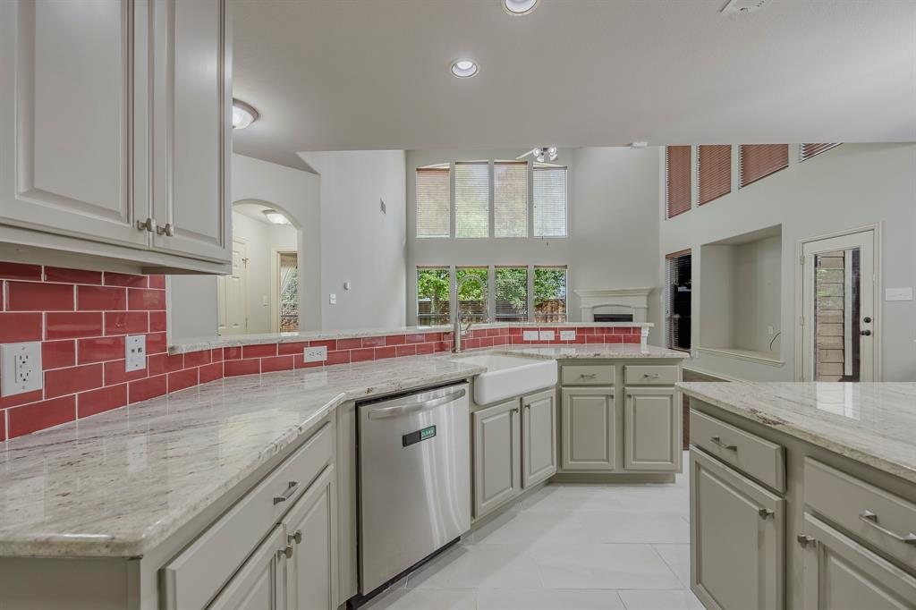 362 Spring Meadow Drive Fairview, TX 75069 - Photo 7 of 38 a kitchen with a sink and cabinets