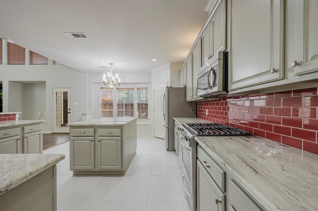 362 Spring Meadow Drive Fairview, TX 75069 - Photo 8 of 38 a kitchen with stainless steel appliances granite countertop a stove and a sink