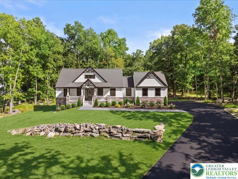 13 Seneca Road Albrightsville, PA 18210 - Photo 1 of 7 A long paved driveway curves toward this craftmans-style home nestled against a dense forest backdrop.