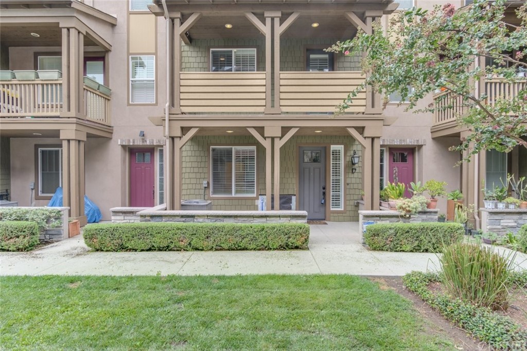 713 South Azusa Avenue, Unit D Azusa, CA 91702 - Photo 2 of 44 a view of a white house with large windows and a table and chairs