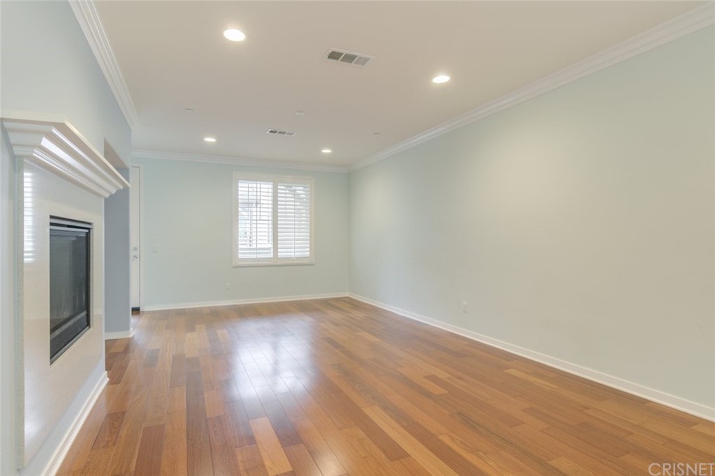 713 South Azusa Avenue, Unit D Azusa, CA 91702 - Photo 13 of 44 an empty room with wooden floor and windows