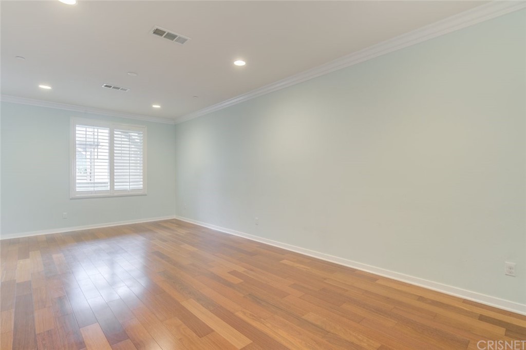 713 South Azusa Avenue, Unit D Azusa, CA 91702 - Photo 14 of 44 an empty room with wooden floor and windows