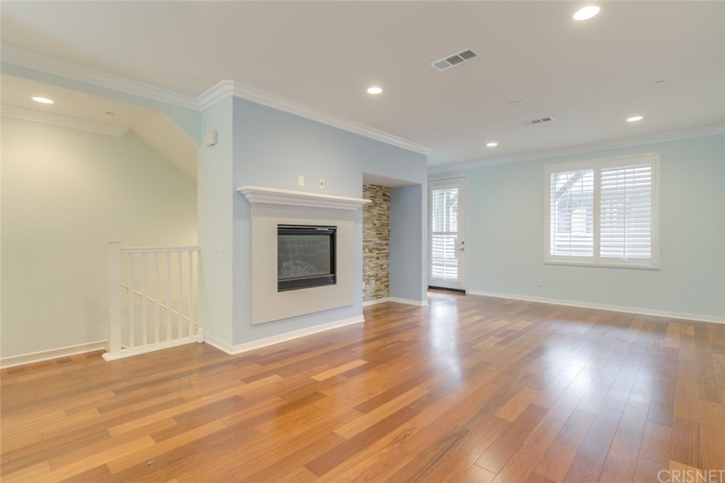 713 South Azusa Avenue, Unit D Azusa, CA 91702 - Photo 15 of 44 a view of an empty room with wooden floor and a window