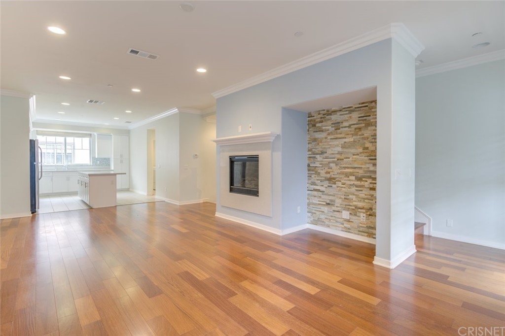 713 South Azusa Avenue, Unit D Azusa, CA 91702 - Photo 16 of 44 a view of empty room with wooden floor and fireplace