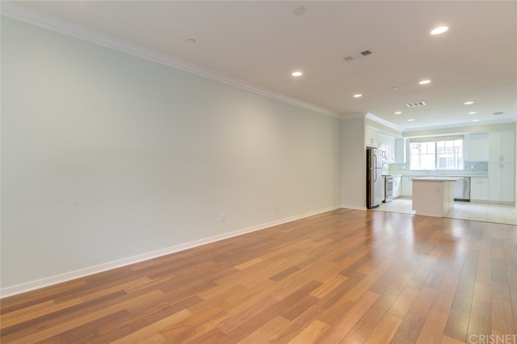 713 South Azusa Avenue, Unit D Azusa, CA 91702 - Photo 17 of 44 a view of empty room with wooden floor and kitchen