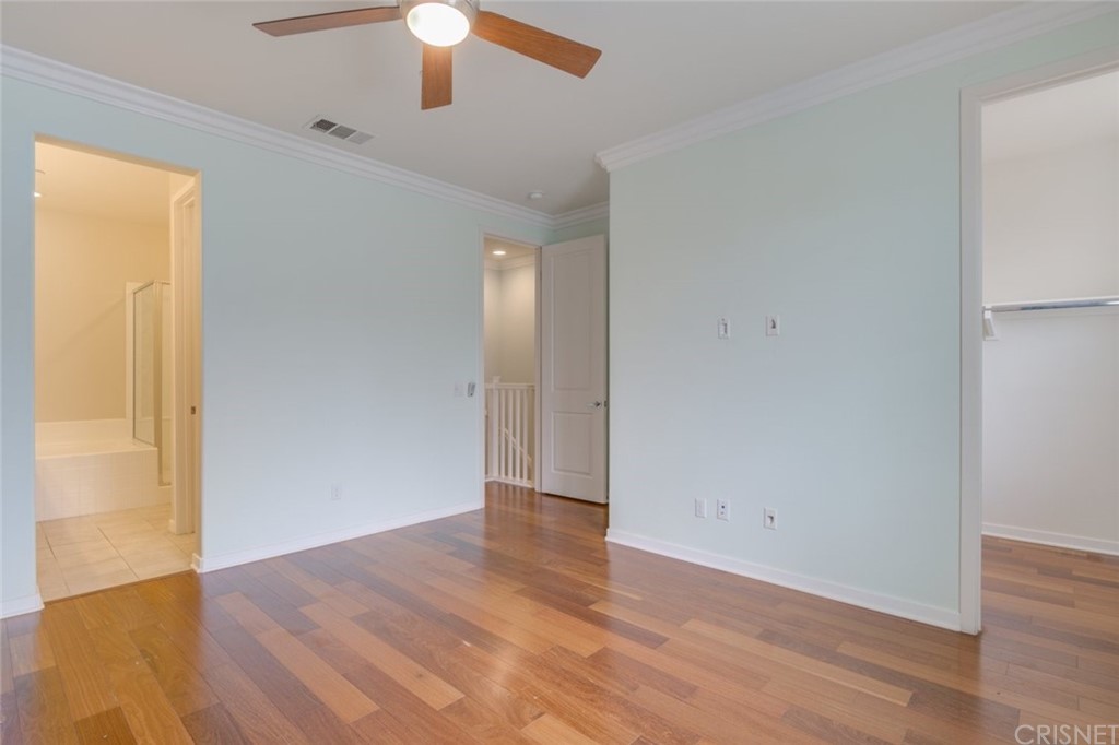 713 South Azusa Avenue, Unit D Azusa, CA 91702 - Photo 29 of 44 an empty room with wooden floor chandelier fan and windows