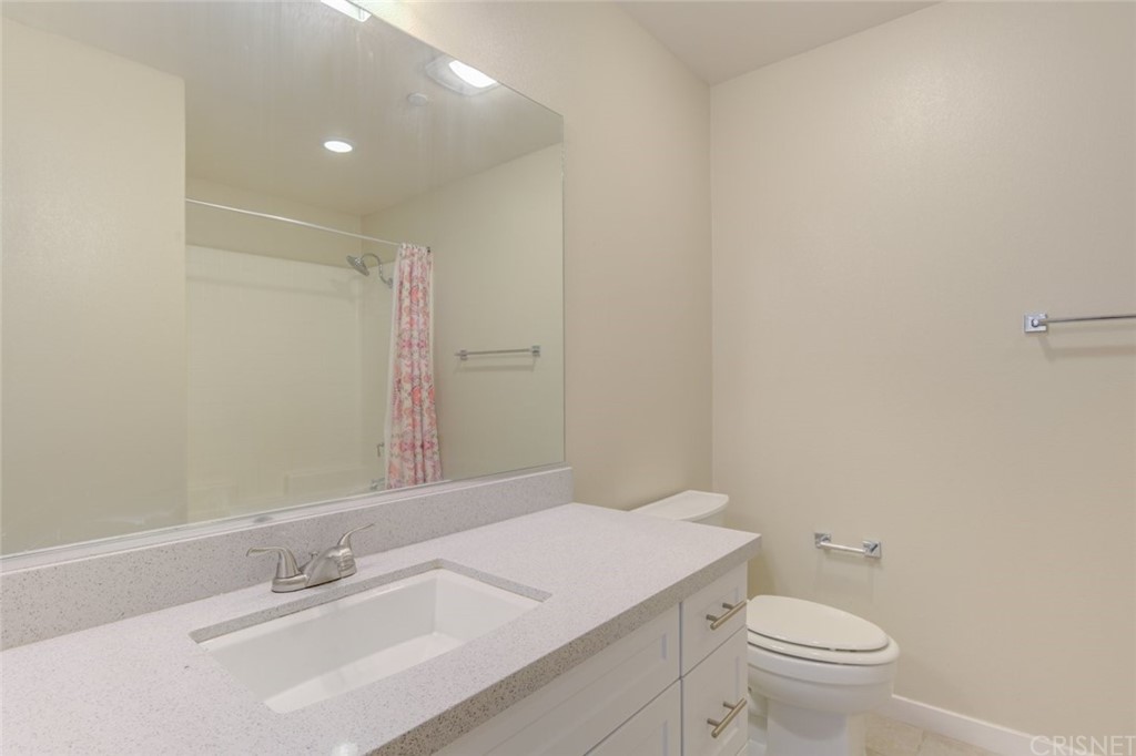 713 South Azusa Avenue, Unit D Azusa, CA 91702 - Photo 10 of 44 a bathroom with a sink a toilet and a mirror
