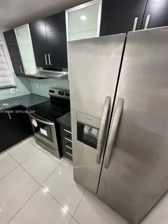 a kitchen with stainless steel appliances a refrigerator and a sink