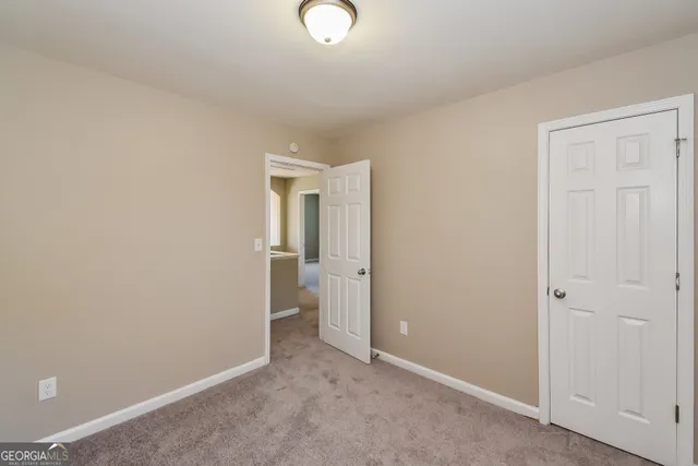 an empty room with closet area
