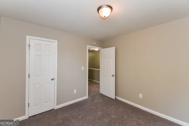 an empty room with closet area