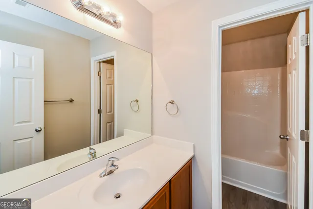 a bathroom with a sink a shower and a mirror
