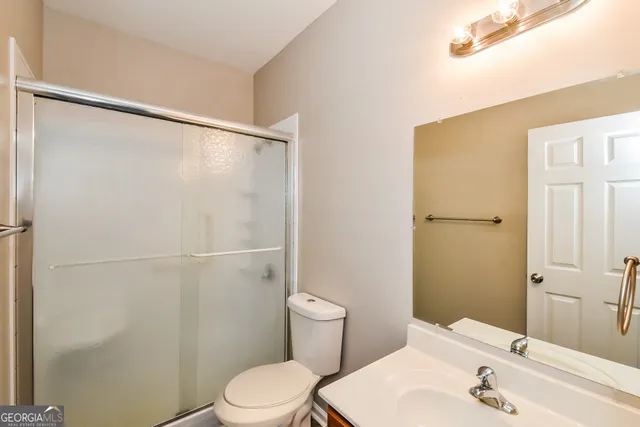 a white toilet sitting next to a bathroom sink