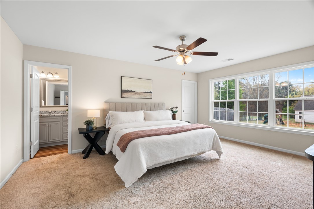 114 Sunny Pt Loop Central, SC 29630 - Photo 12 of 25 This primary bedroom offers ample natural light and an en-suite bathroom for ultimate comfort and convenience.