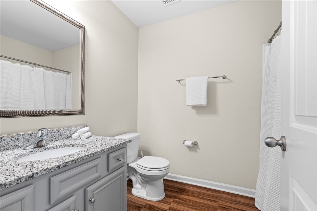 114 Sunny Pt Loop Central, SC 29630 - Photo 14 of 25 This bathroom features a contemporary vanity with a granite countertop and rich wood flooring.