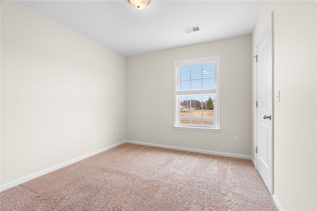 114 Sunny Pt Loop Central, SC 29630 - Photo 15 of 25 This cozy bedroom features plush carpet, a bright window, and a fresh, inviting atmosphere.