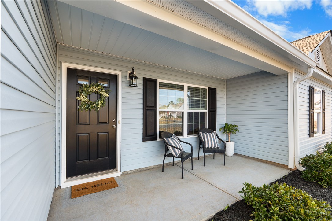 114 Sunny Pt Loop Central, SC 29630 - Photo 4 of 25 A welcoming front porch features light blue siding and classic black shutters.