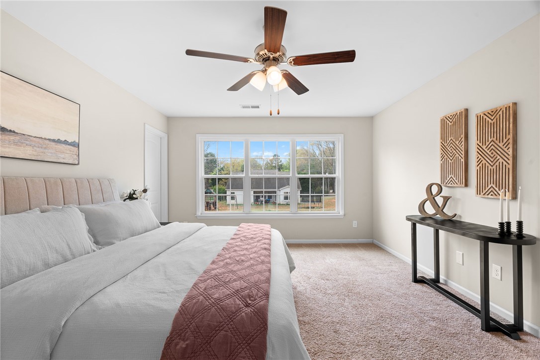 114 Sunny Pt Loop Central, SC 29630 - Photo 7 of 25 This light-filled bedroom offers a serene retreat with expansive windows and a comfortable ambiance.