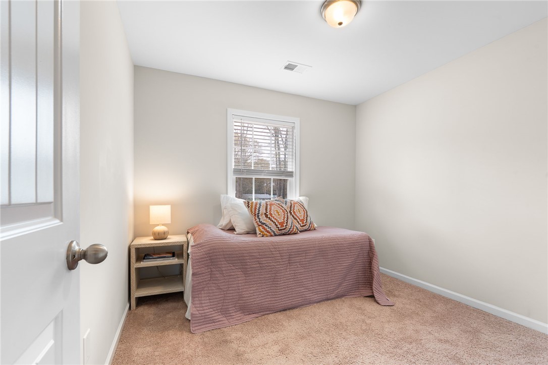 114 Sunny Pt Loop Central, SC 29630 - Photo 8 of 25 This cozy bedroom features warm carpeting and ample natural light through a classic window.