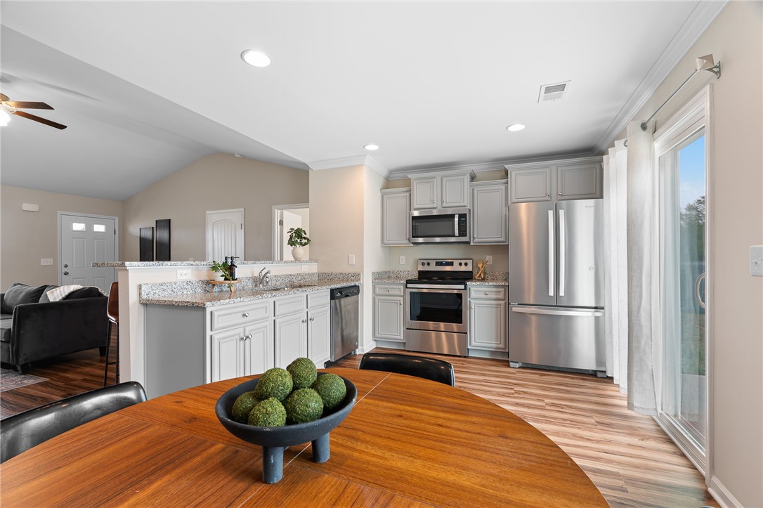 114 Sunny Pt Loop Central, SC 29630 - Photo 10 of 25 This bright kitchen features modern appliances, granite counters, and seamless flow into living spaces.