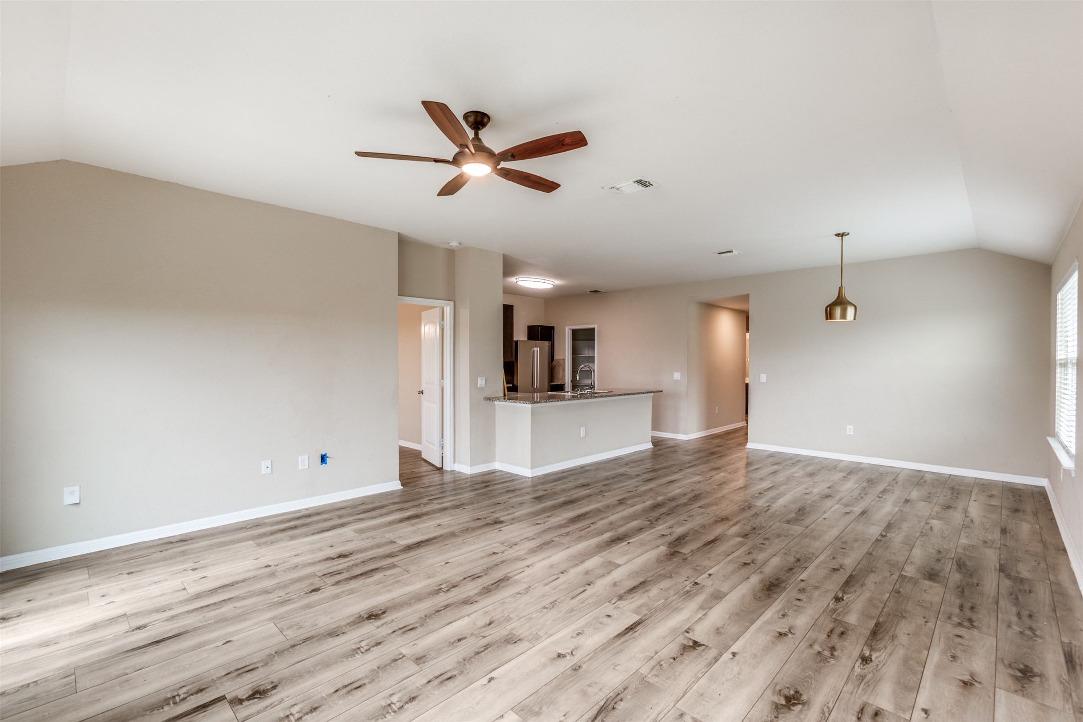 2909 Centrum Drive Austin, TX 78754 - Photo 11 of 30 Spacious living area featuring light-toned flooring, a ceiling fan, and a contemporary pendant light fixture