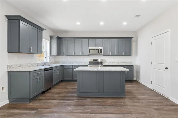 a kitchen with a sink window and cabinets