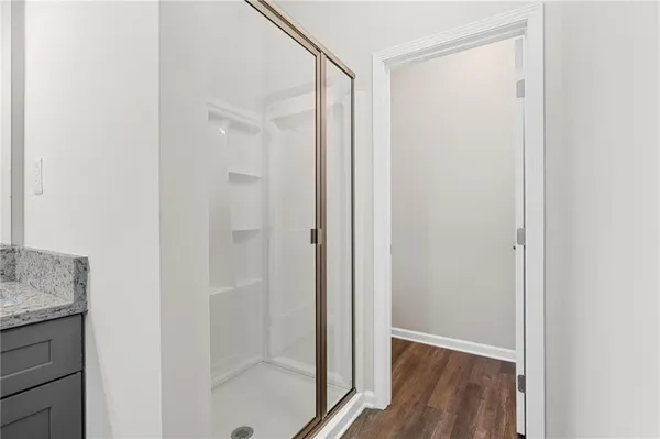 a bathroom with a shower and a sink