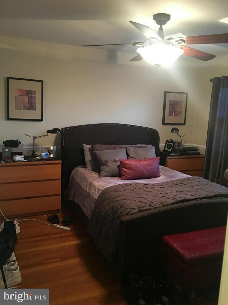 1242 Cedarcroft Road Baltimore, MD 21239 - Photo 14 of 22 a bedroom with a bed and a chandelier