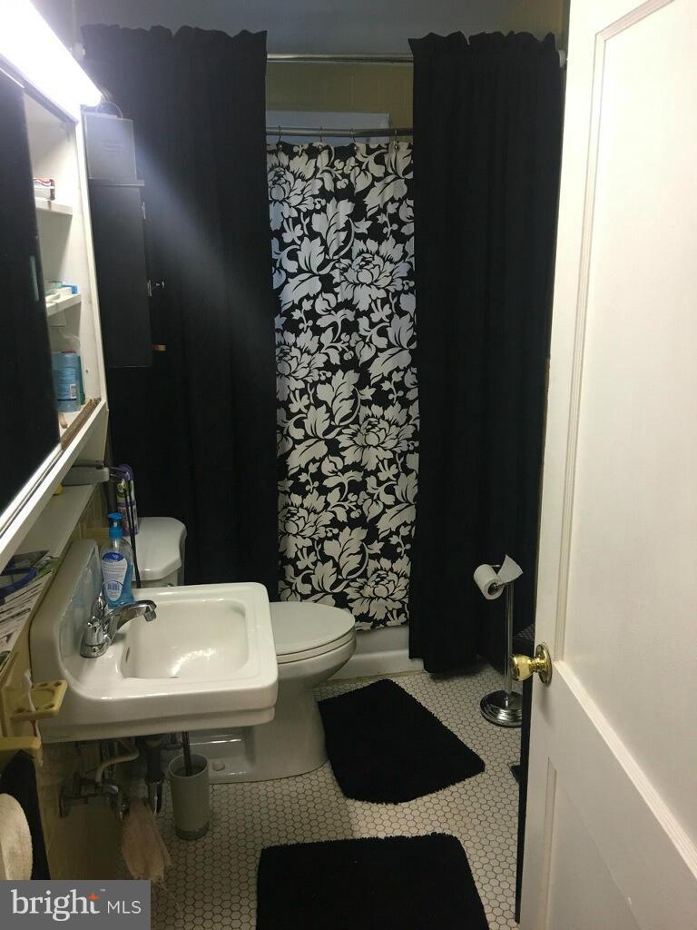 1242 Cedarcroft Road Baltimore, MD 21239 - Photo 16 of 22 a bathroom with a sink and a mirror