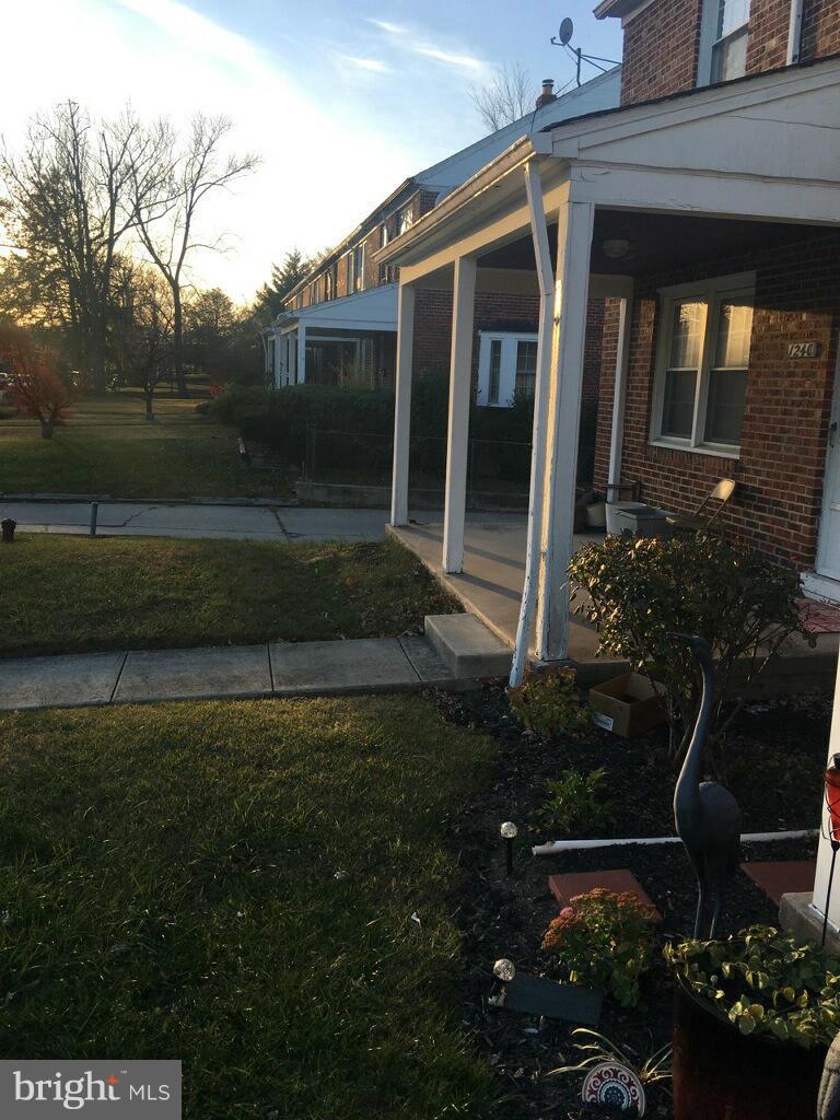 1242 Cedarcroft Road Baltimore, MD 21239 - Photo 5 of 22 a front view of a house with garden