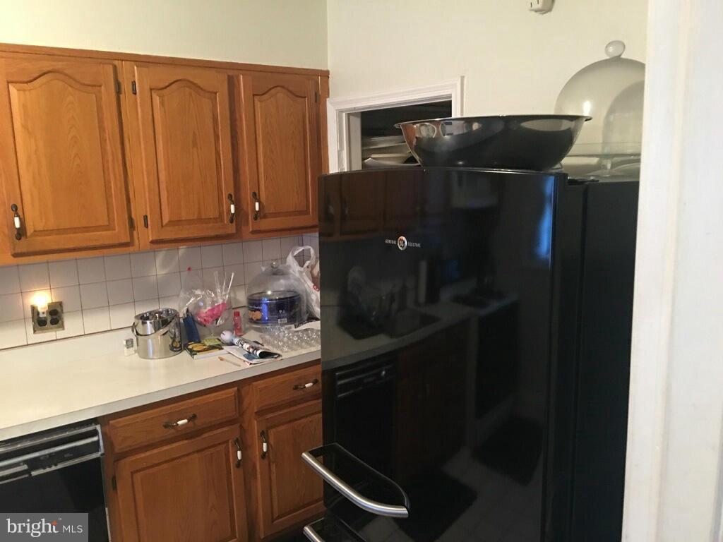 1242 Cedarcroft Road Baltimore, MD 21239 - Photo 6 of 22 a kitchen with a refrigerator and cabinets