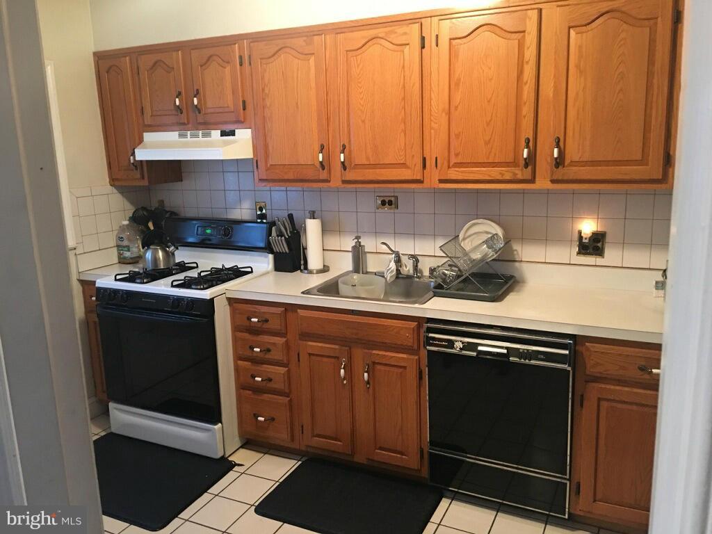 1242 Cedarcroft Road Baltimore, MD 21239 - Photo 7 of 22 a kitchen with stainless steel appliances granite countertop a stove a sink and a microwave