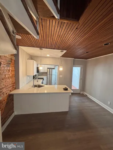 a kitchen with a sink a stove and cabinets