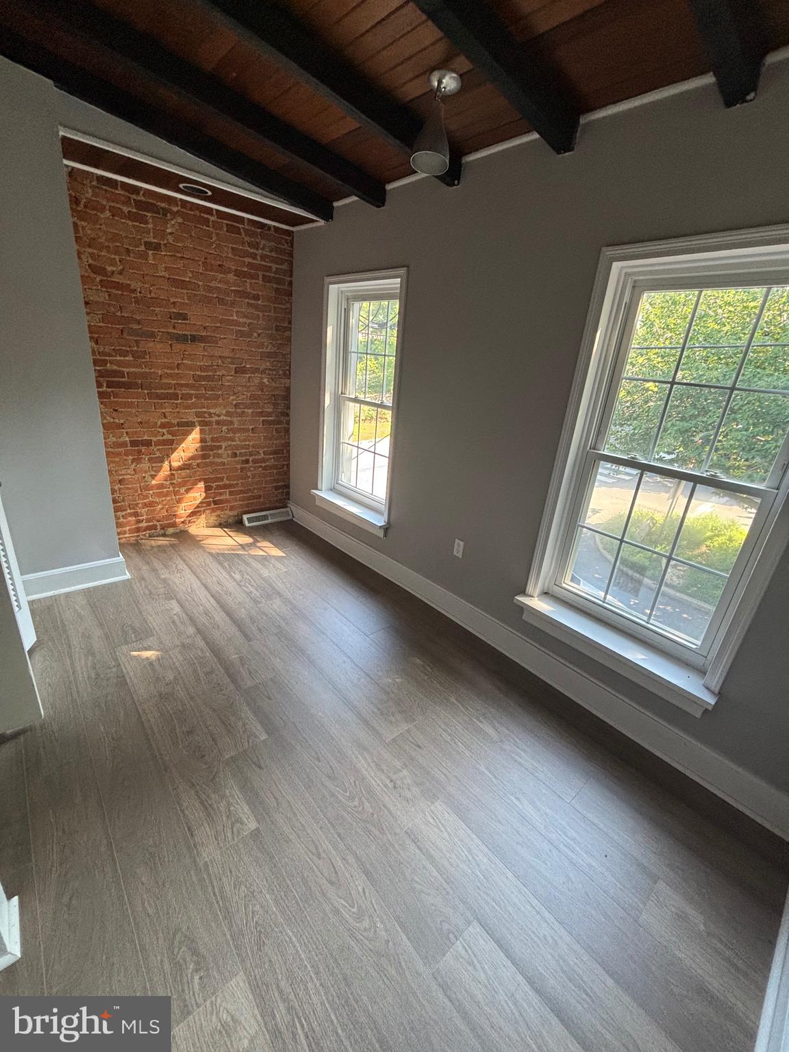 903 Lovering Avenue Wilmington, DE 19806 - Photo 10 of 16 a view of an empty room with wooden floor and a window