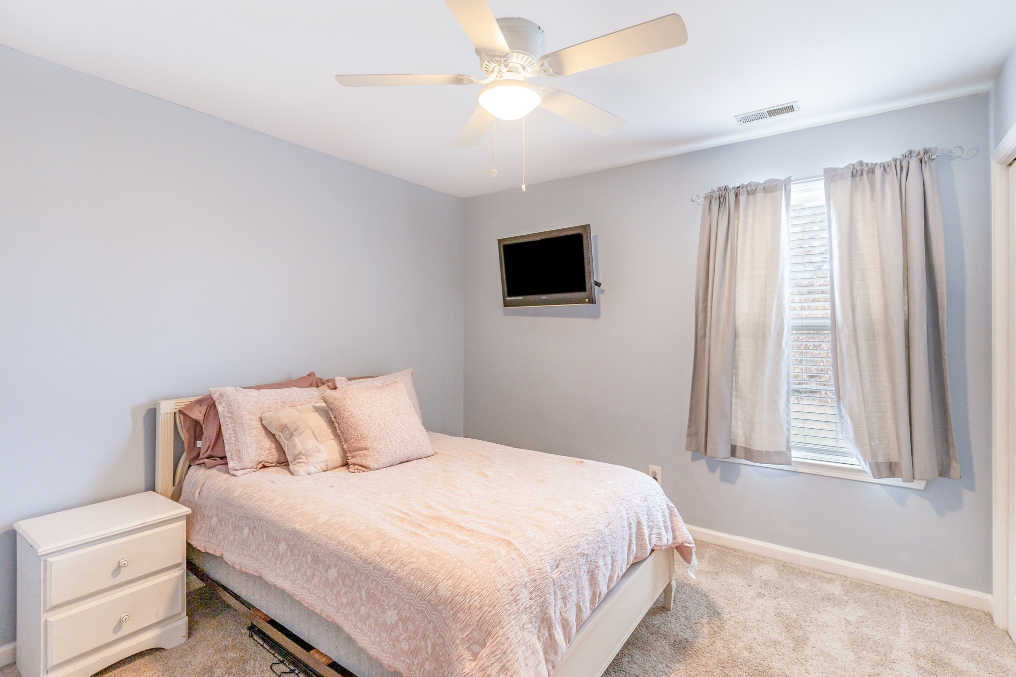 2261 Dewey Drive Spring Hill, TN 37174 - Photo 22 of 26 a bedroom with a bed and a flat screen tv