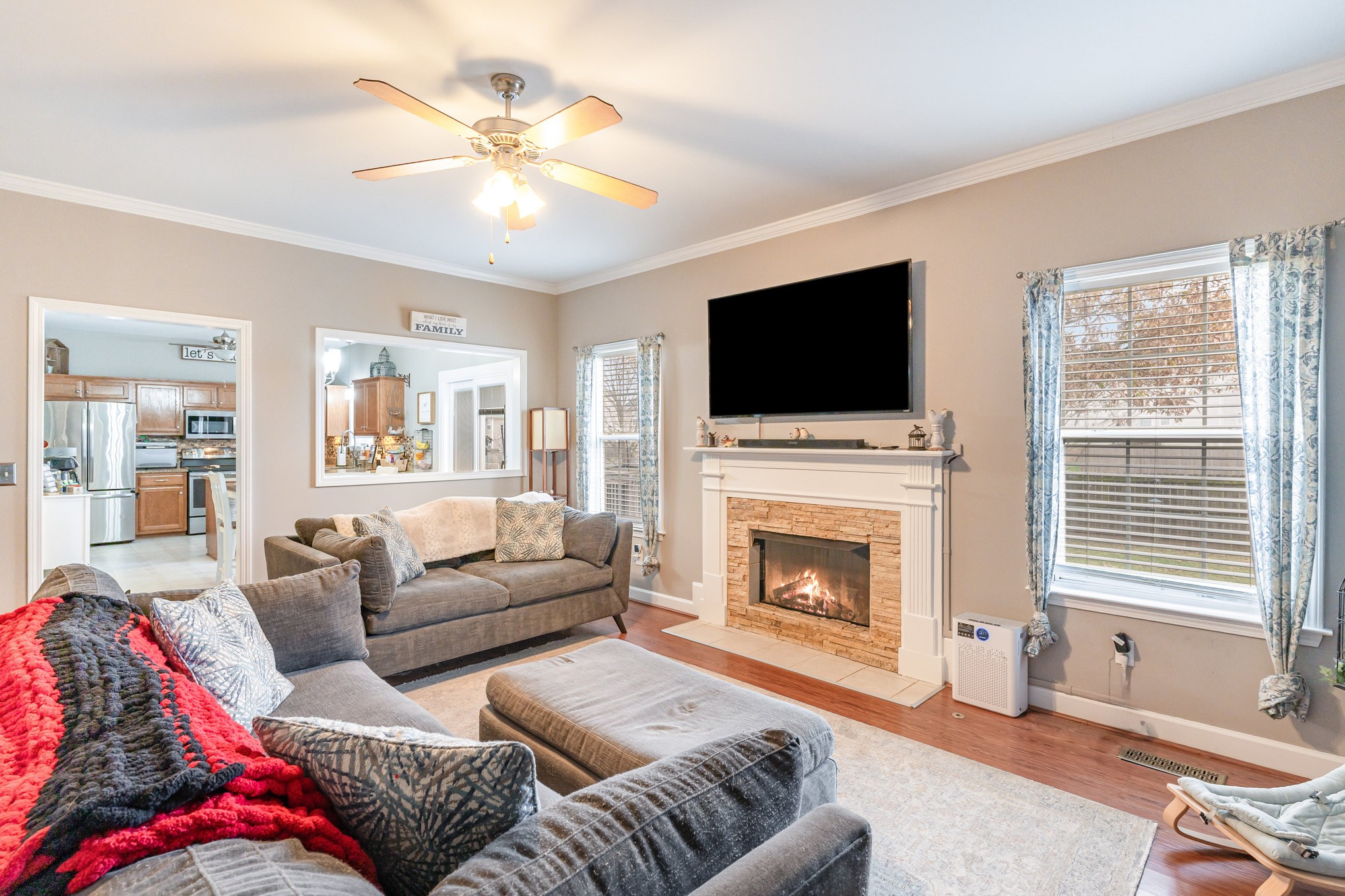 2261 Dewey Drive Spring Hill, TN 37174 - Photo 5 of 26 a living room with furniture a fireplace and a flat screen tv