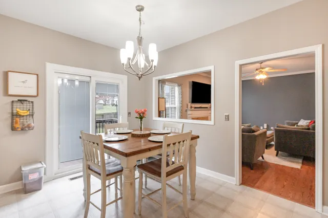 a view of a dining room with furniture and chandelier