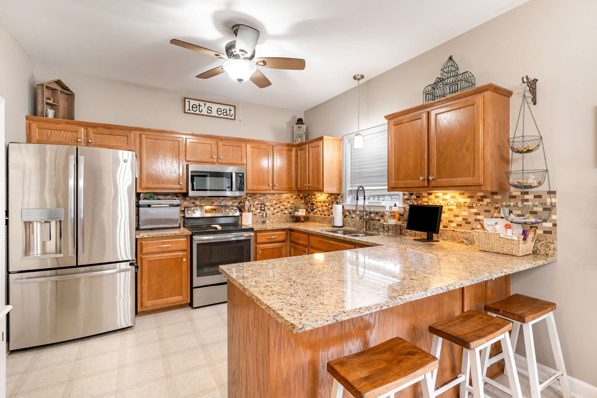 2261 Dewey Drive Spring Hill, TN 37174 - Photo 8 of 26 a kitchen with stainless steel appliances granite countertop a sink a stove and refrigerator