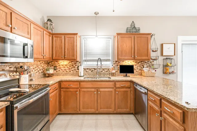 a kitchen with a sink stove and cabinets