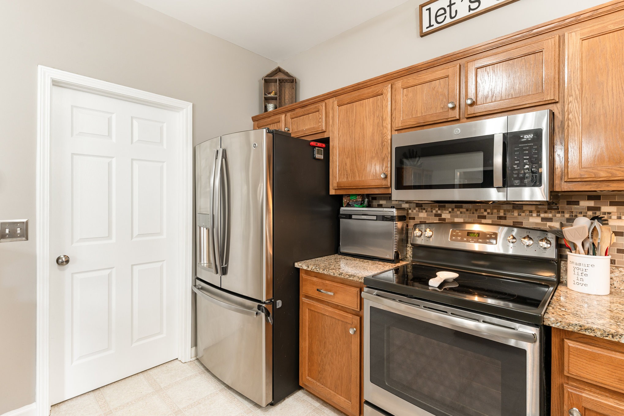 2261 Dewey Drive Spring Hill, TN 37174 - Photo 10 of 26 a kitchen with stainless steel appliances a stove a microwave and a refrigerator